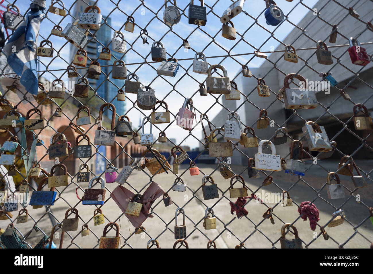 Many padlocks secured to a wire fence in Wheler Street, London E1 Stock
