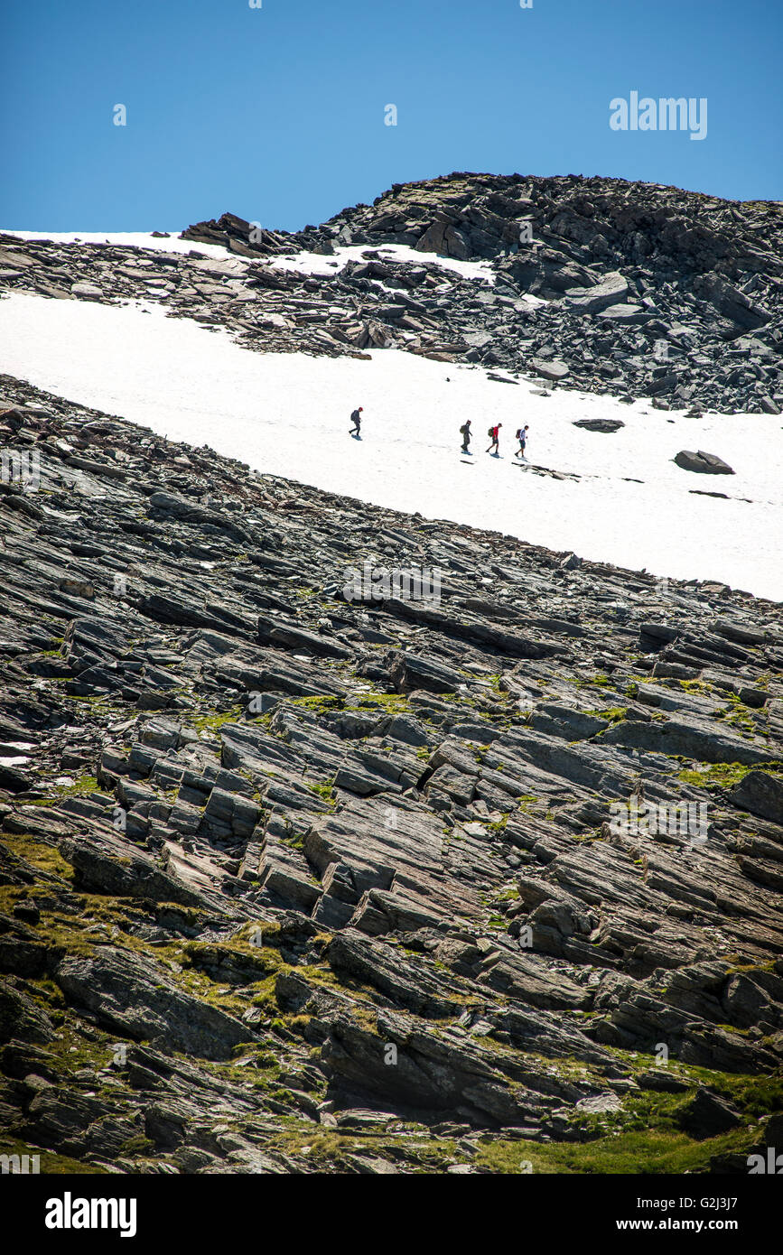 Hikers Crossing Snowy Terrain in Mountains, Pointe Droset, Val Cenis Vanoise, France Stock Photo