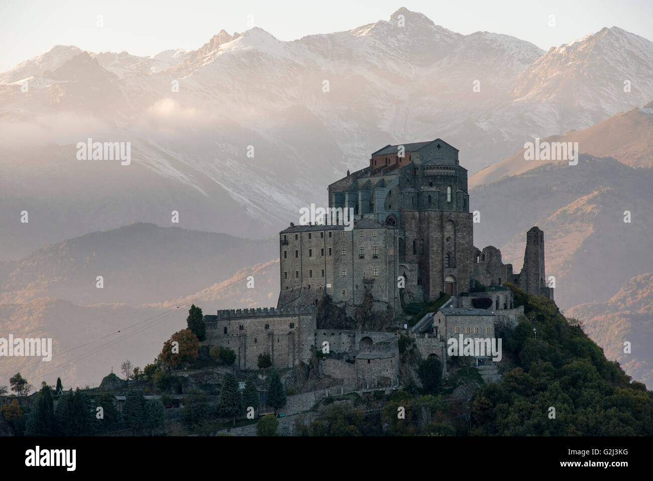 Sacra di San Michele at Sunset with Alps in Background, Italy Stock Photo