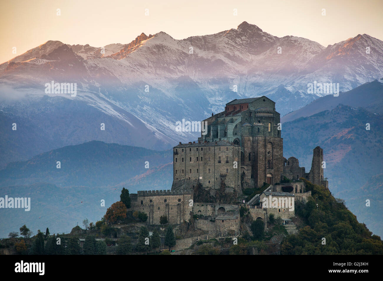 Sacra di San Michele at Sunset with Alps in Background, Italy Stock Photo