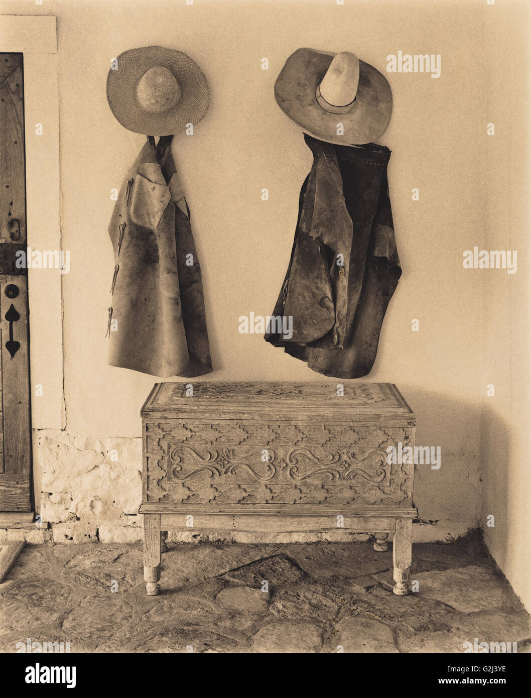 Cowboy Chaps and Hats Hanging on Wall Stock Photo Alamy