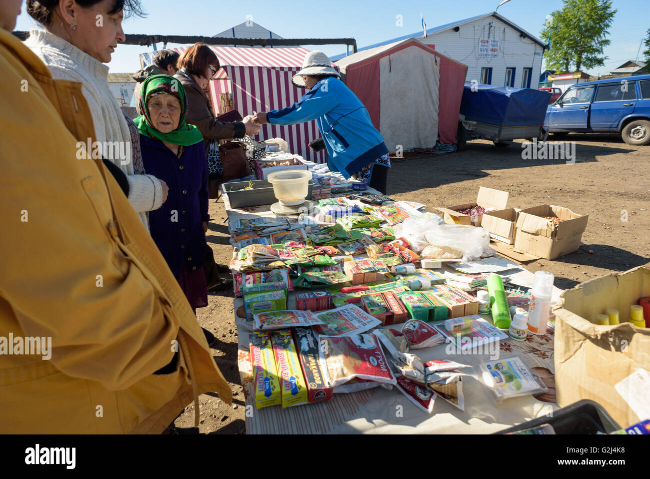 A Russian seed seller sells packets of vegetable seeds to members of