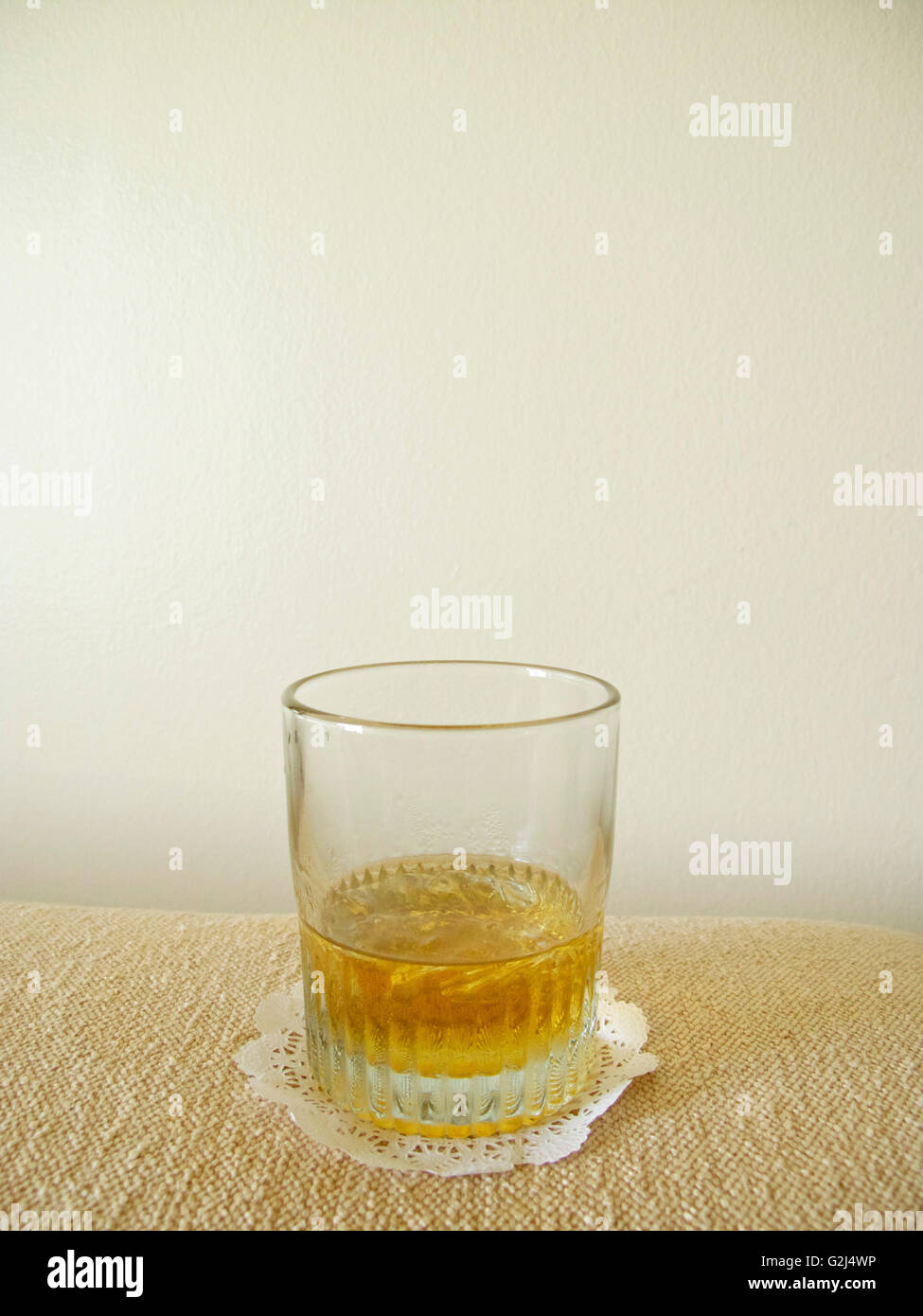 Glass of Bourbon on Paper Doily Stock Photo