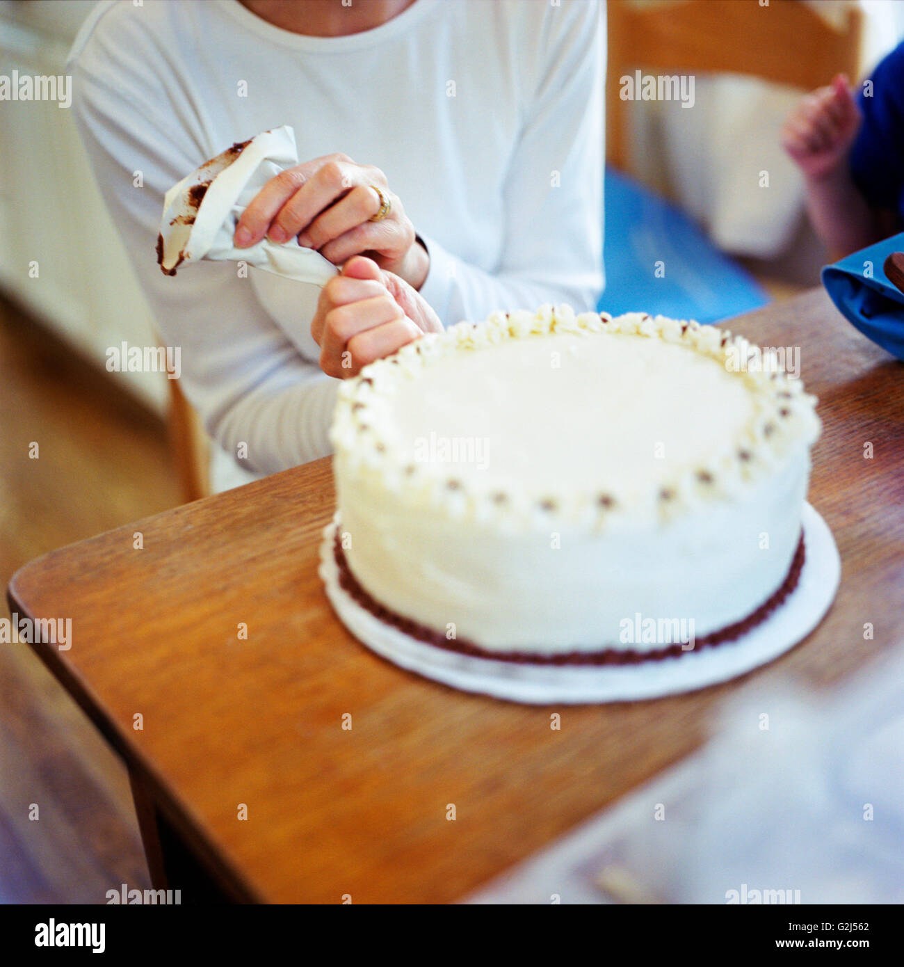 Woman Decorating a Cake Stock Photo