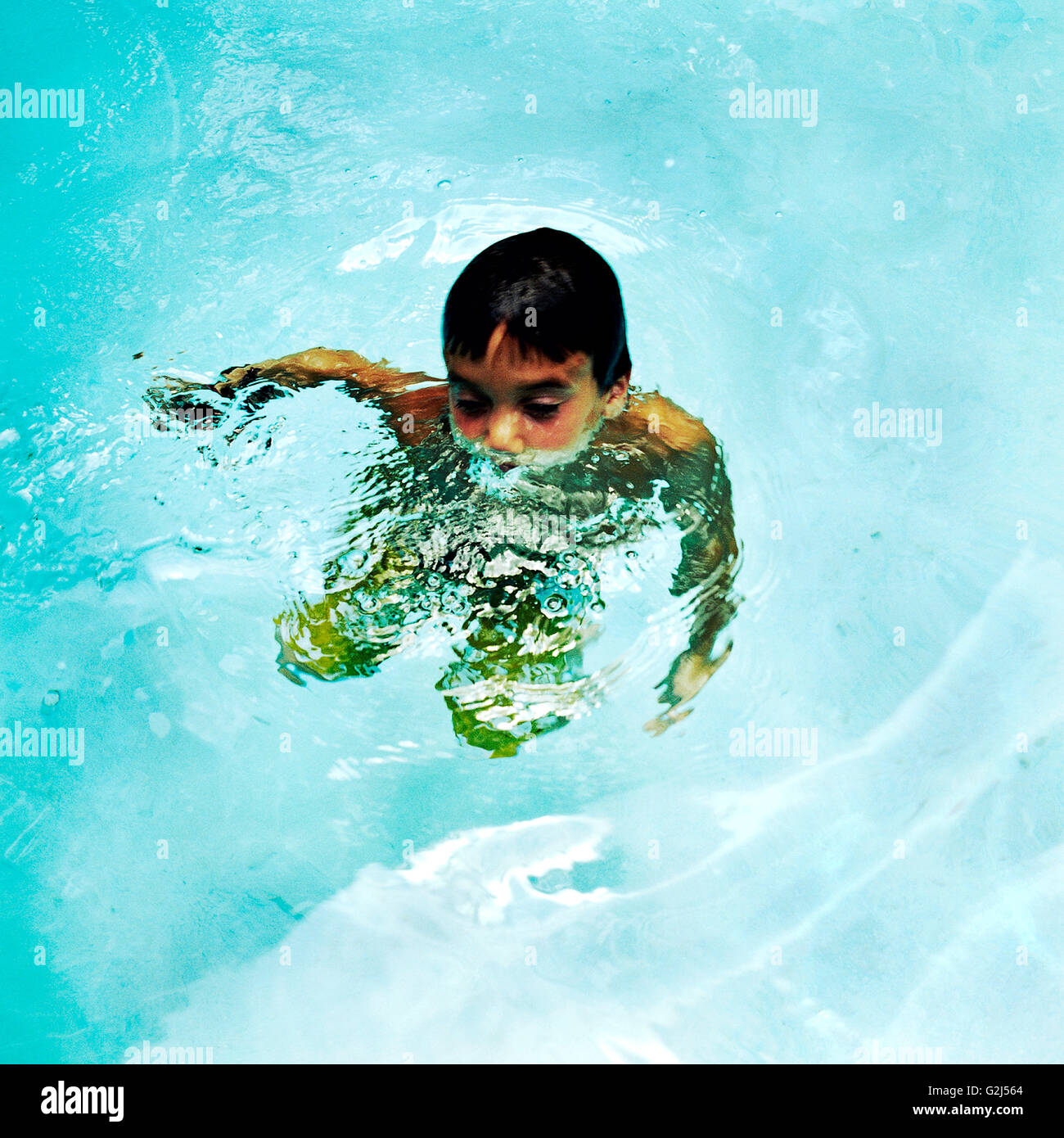 Child Treading Water in Swimming Pool Stock Photo