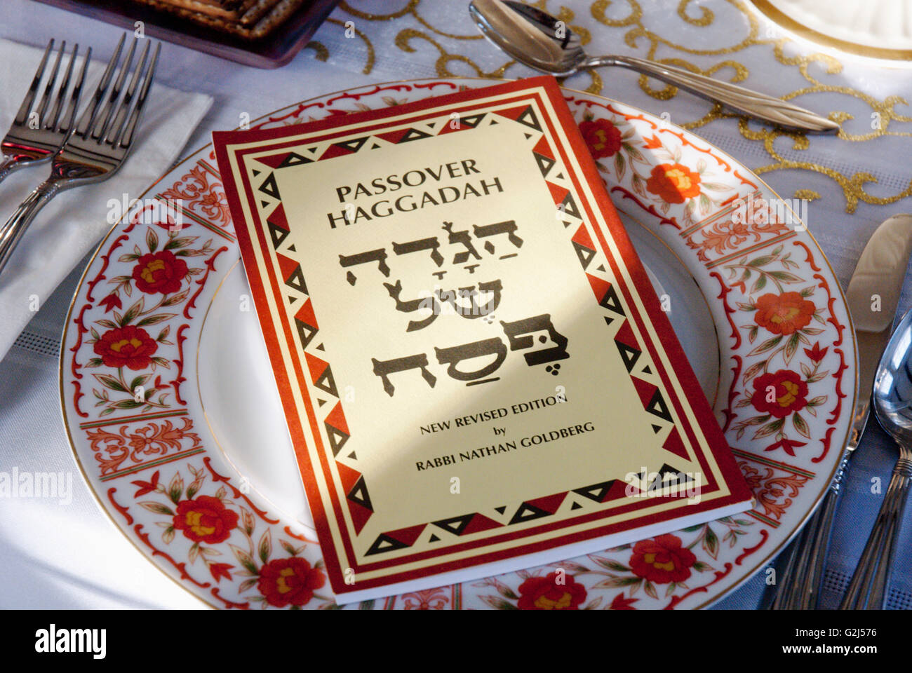 Passover Haggadah on Table Setting Stock Photo