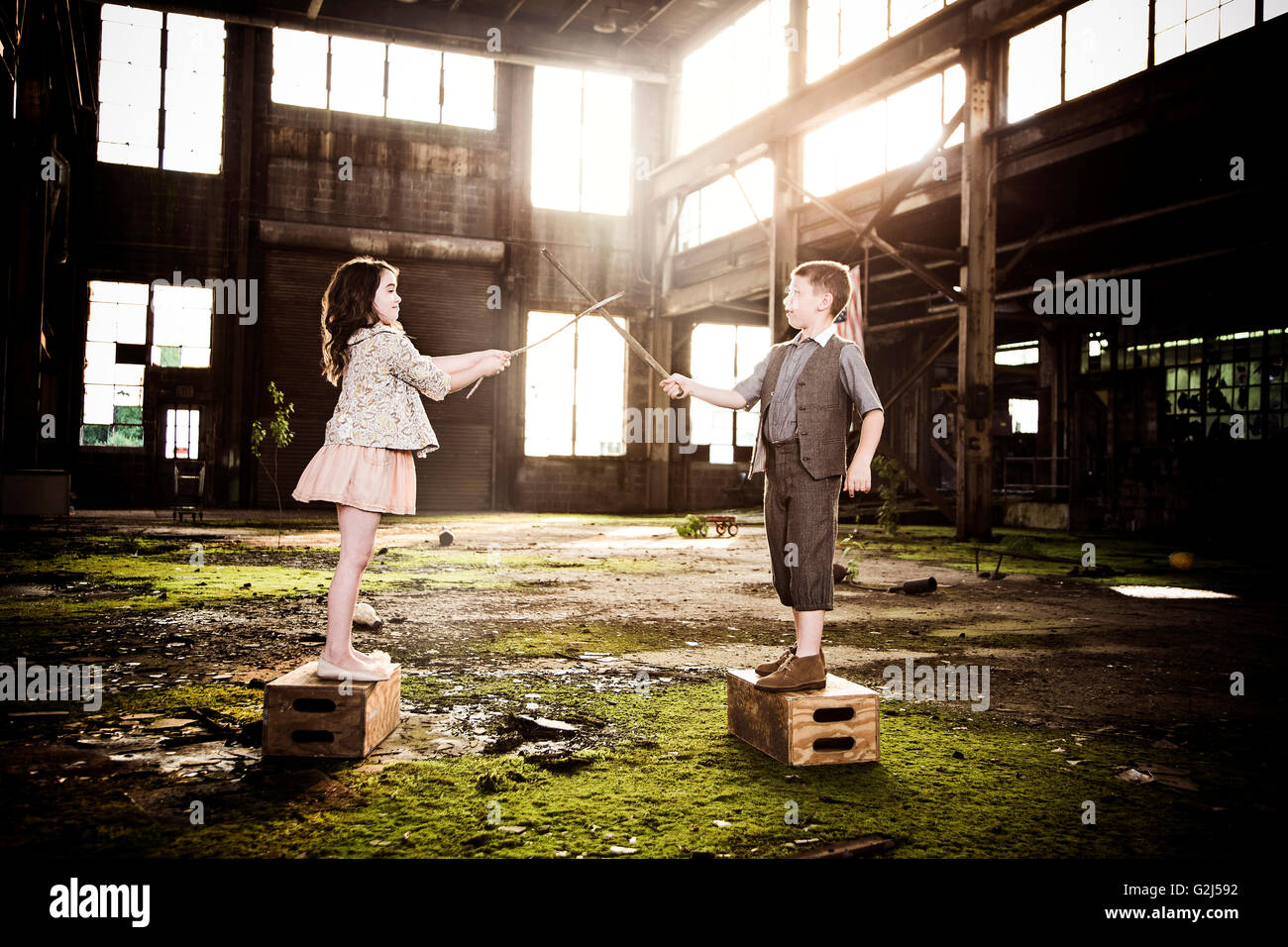 Two Children Play Fighting in Abandoned Warehouse Stock Photo Alamy