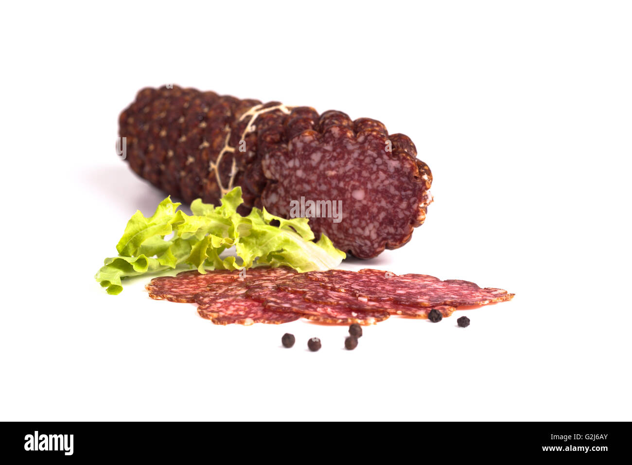 Sliced salami with black pepper isolated on white background Stock