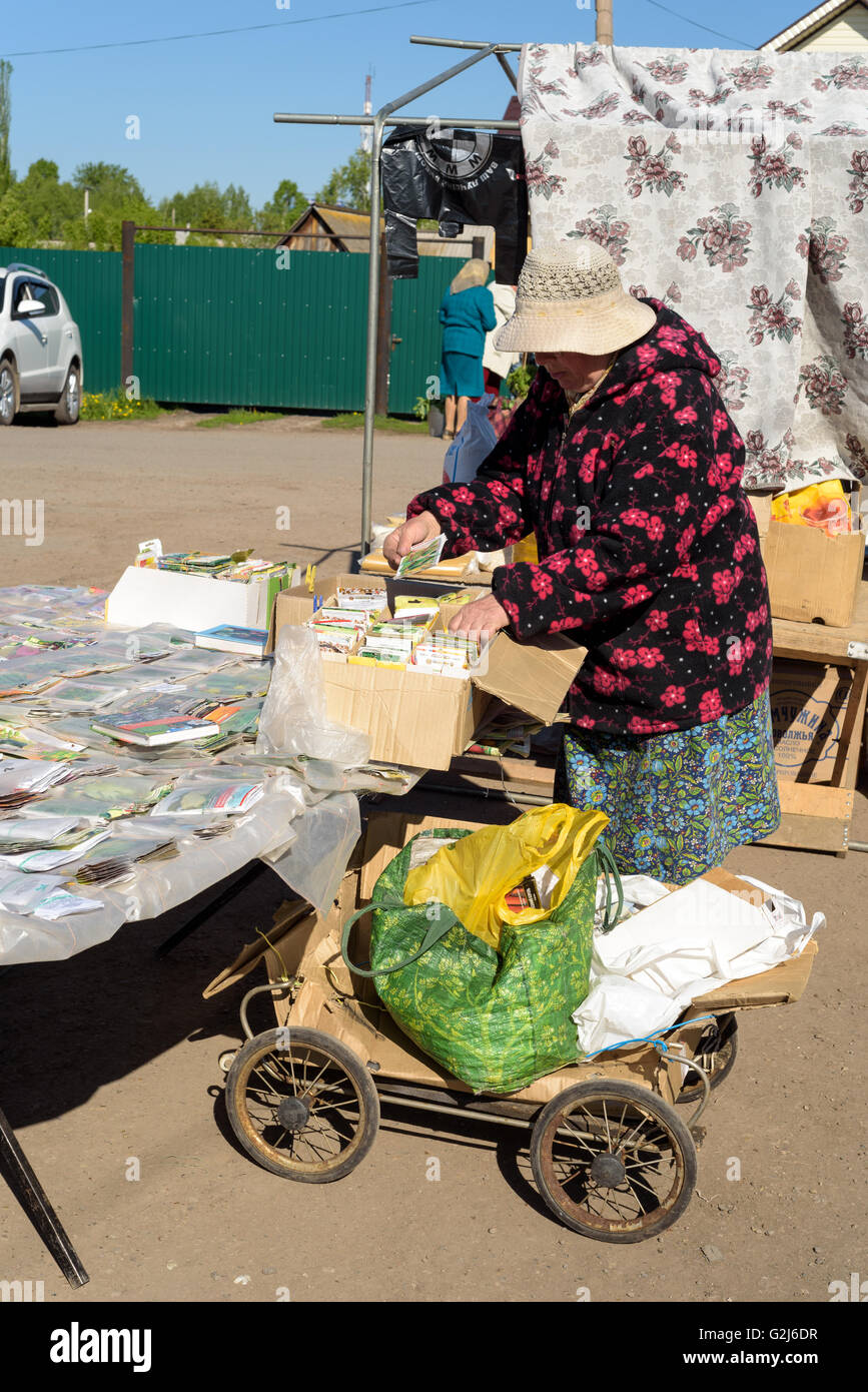 A Russian seed seller sells packets of vegetable seeds to members of