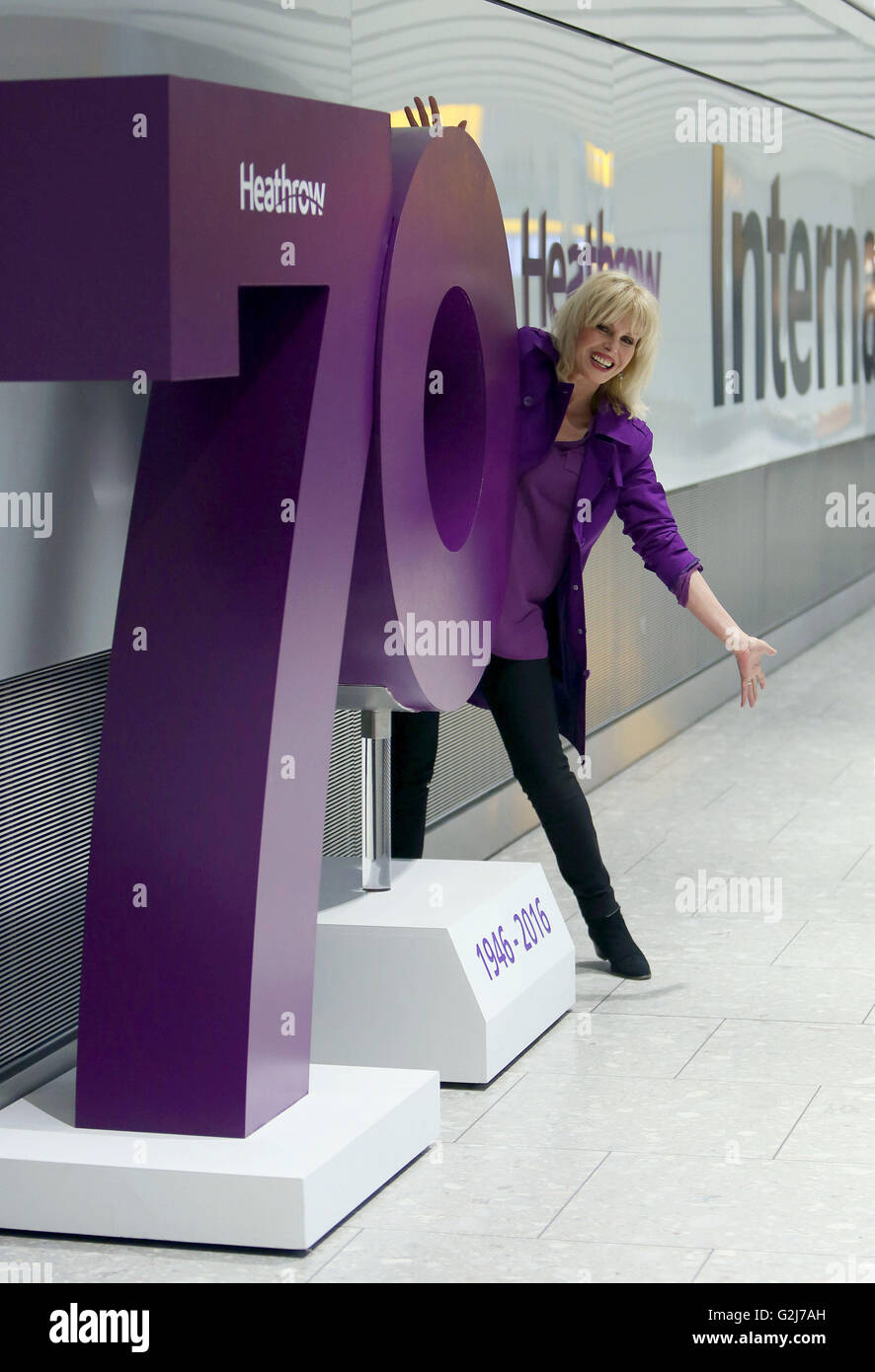 Joanna Lumley poses by one of a series plaques which each represent 'an iconic moment of British culture' from the past seven decades, on the concourse at Terminal 5, Heathrow Airport, to mark the airport's 70th anniversary. Stock Photo