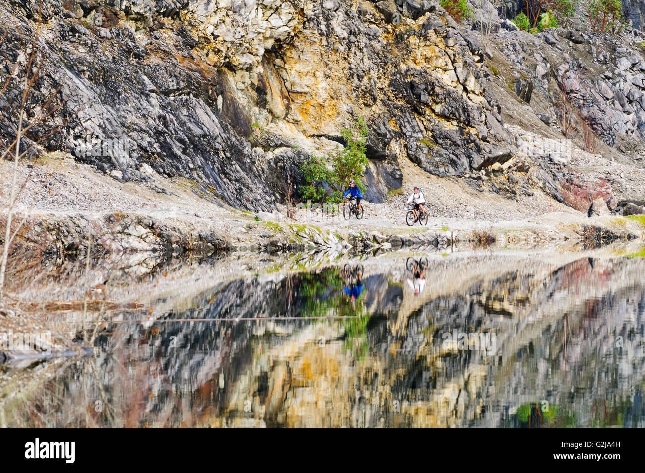 Two mountain bikers bike around the Quarry in Cobble Hill, British Columbia. Stock Photo