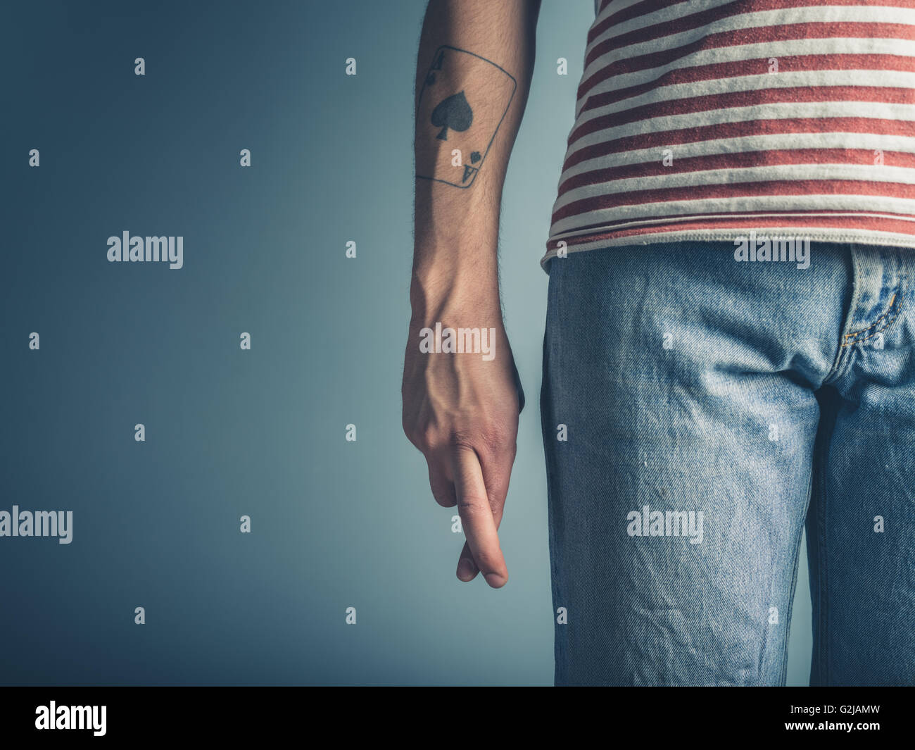 A young man is crossing his fingers Stock Photo