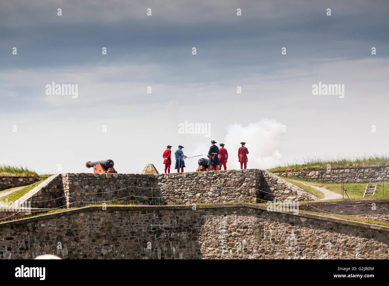 Soldiers firing a cannon at the King's Bastion in the Fortress of Louisbourg National Historic Site of Canada,  Nova Scotia Stock Photo