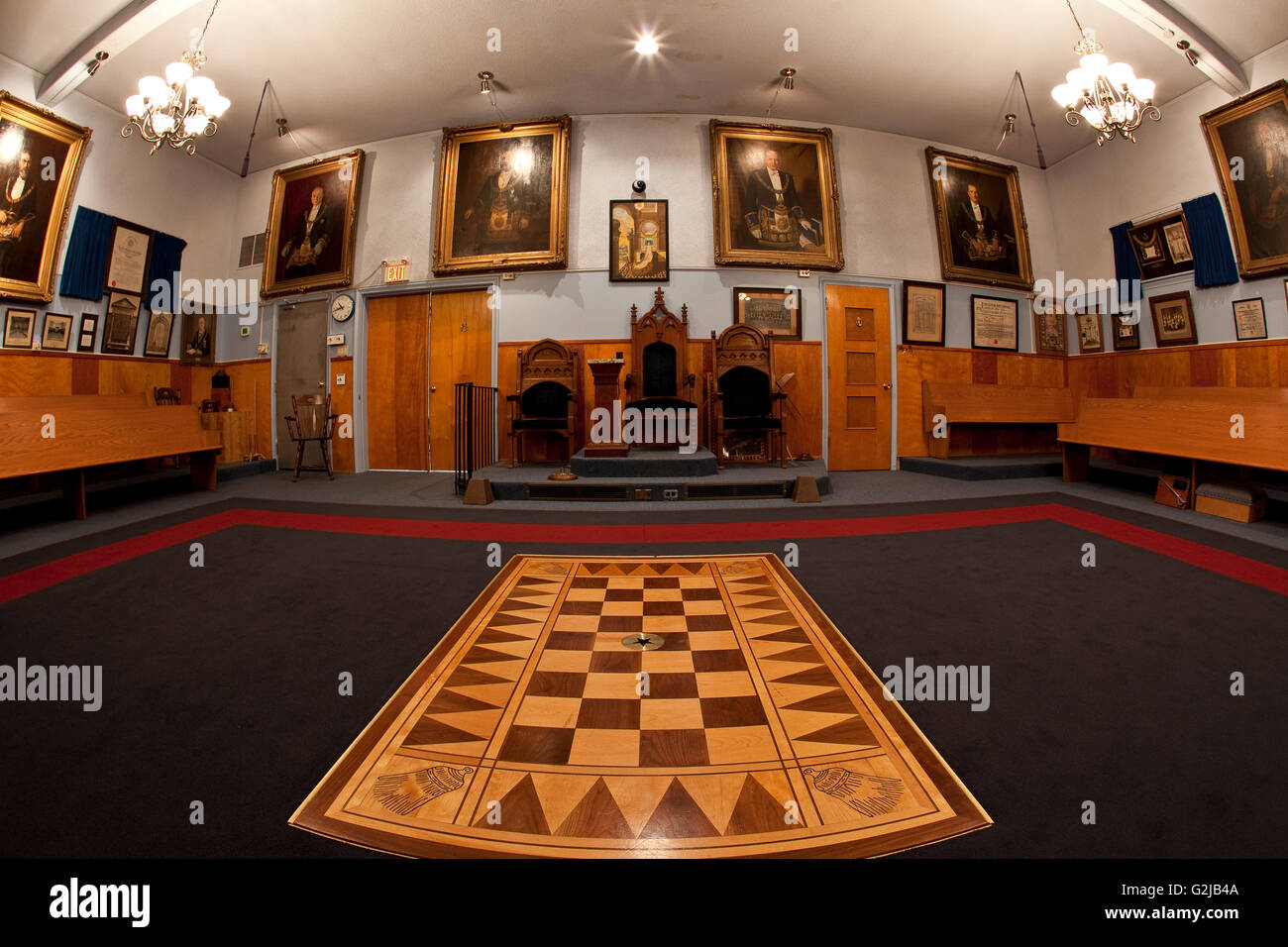 Inside Masonic Hall looking toward Senior Warden's Chair flanked Junior Deacon's Chair on left Junior Warden's Chair on right Stock Photo