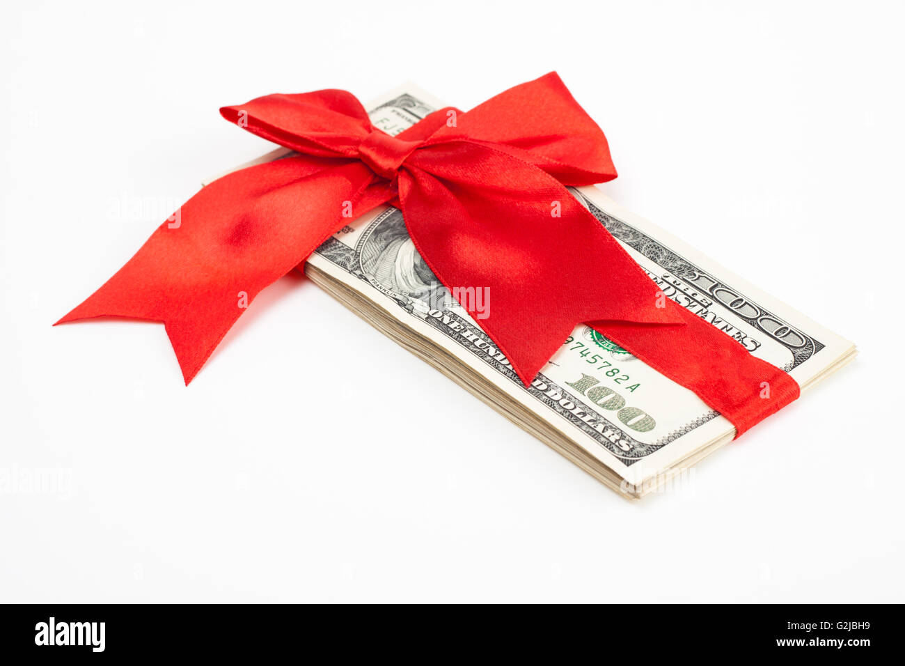 dollars wrapet up with a red ribbon isolated on white background Stock Photo