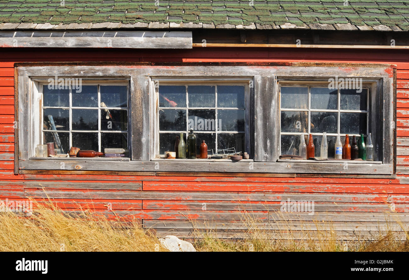 Old bottles on window sill of old farm building, Laverna, Saskatchewan, Canada Stock Photo