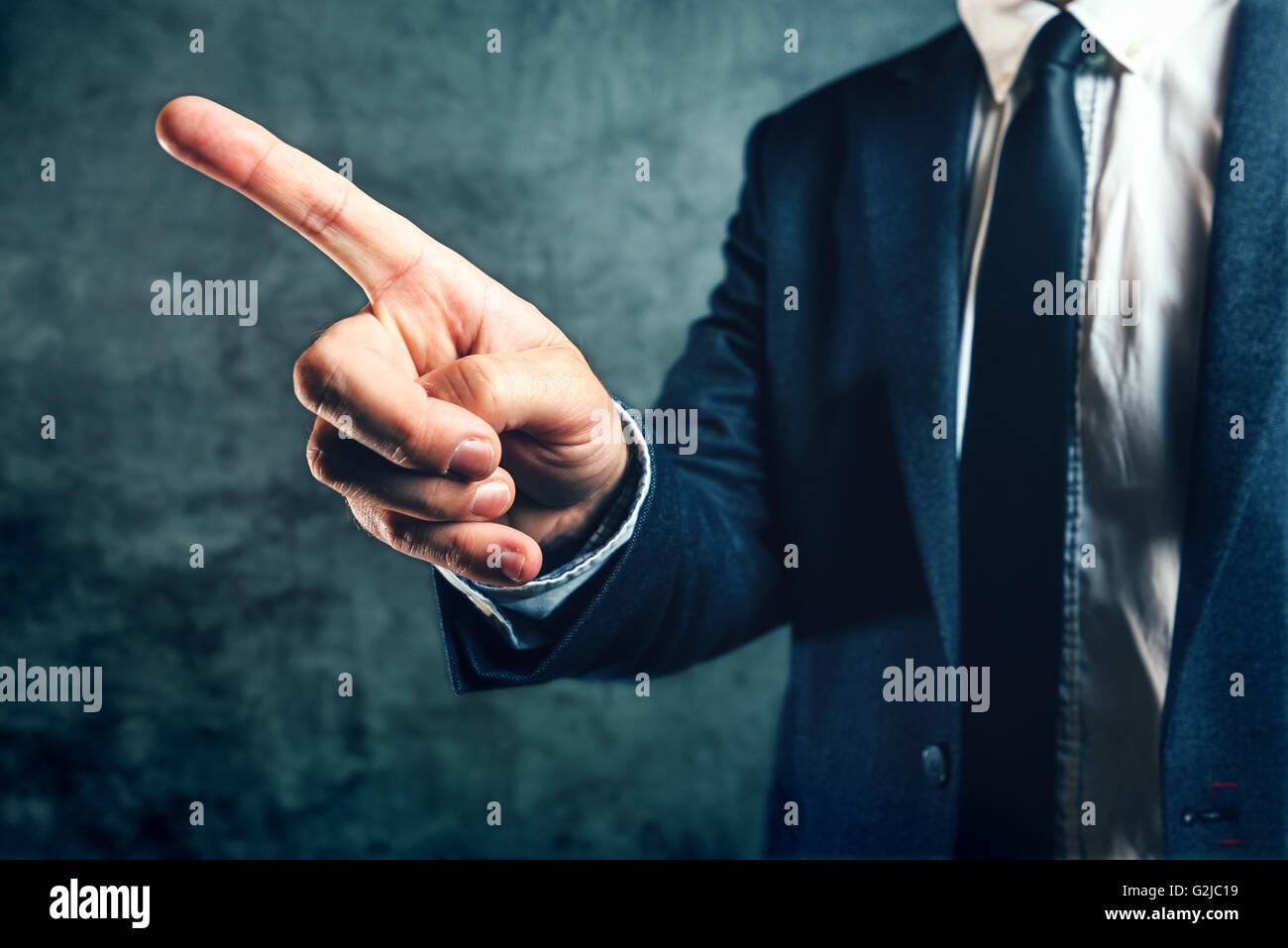 Getting fired from job, office manager showing way out with finger pointing to exit door. Stock Photo