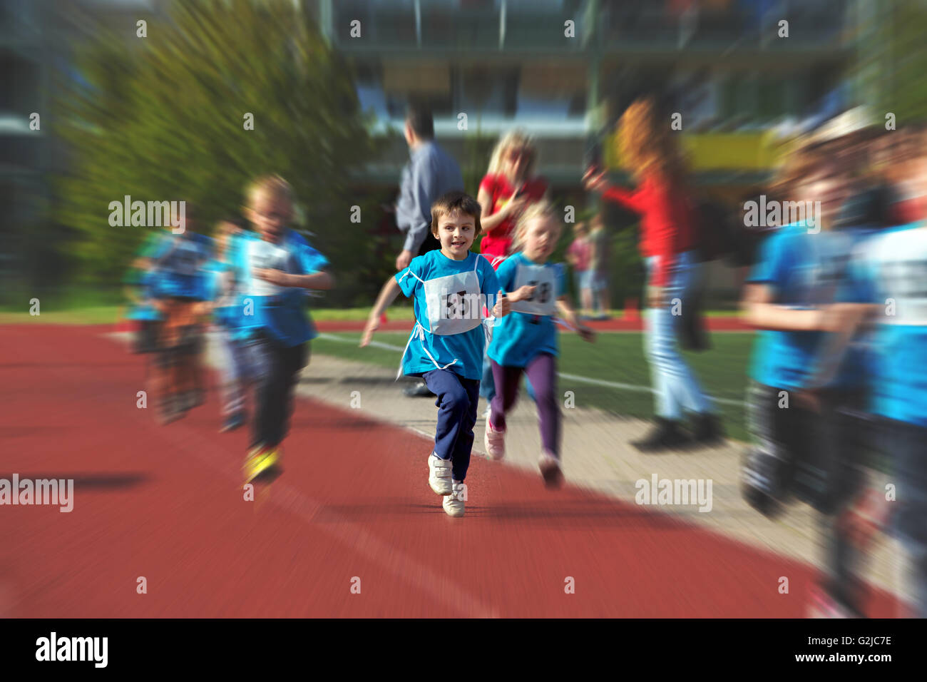 Young preschool children, running on track in a marathon competition ...