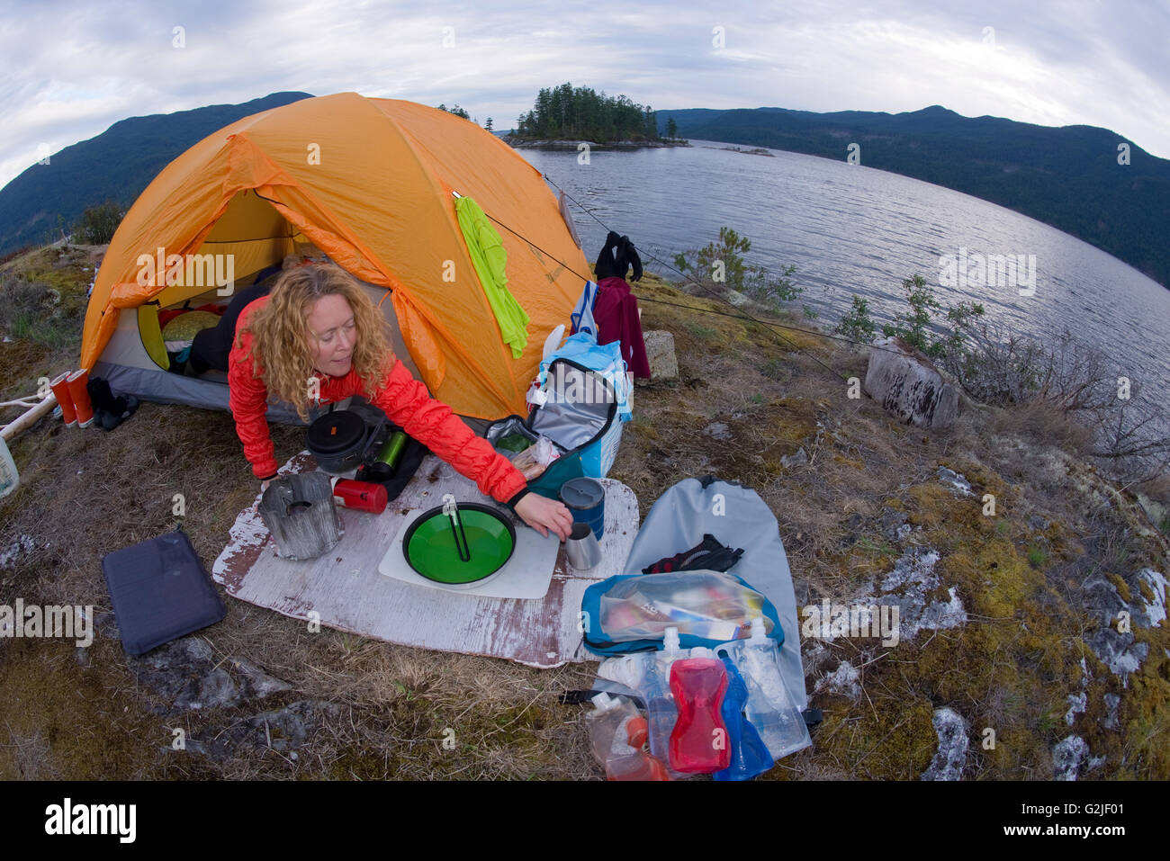 Woman in tent, camping at Kunechin Point, Sechelt Inlet, Gibsons, Sunshine Coast, British Columbia, Canada Stock Photo