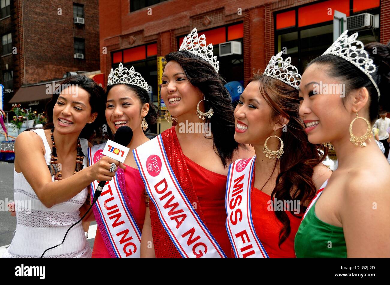 New York City:  Filippina beauty queens being interviewed at the annual Philippines Independence Day Parade on Madison Avenue Stock Photo
