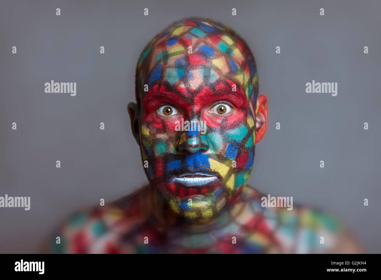 Shocked Superhero portrait, colorful face art with tilt shift and motion blur effect. Stock Photo