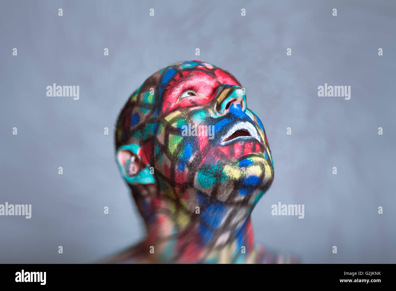 Surprised Superhero portrait, colorful face art with tilt shift and motion blur effect. Stock Photo