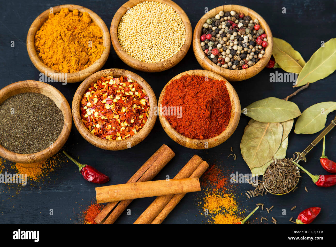 Spices powders and seeds with chili peppers and bay leaves Stock Photo