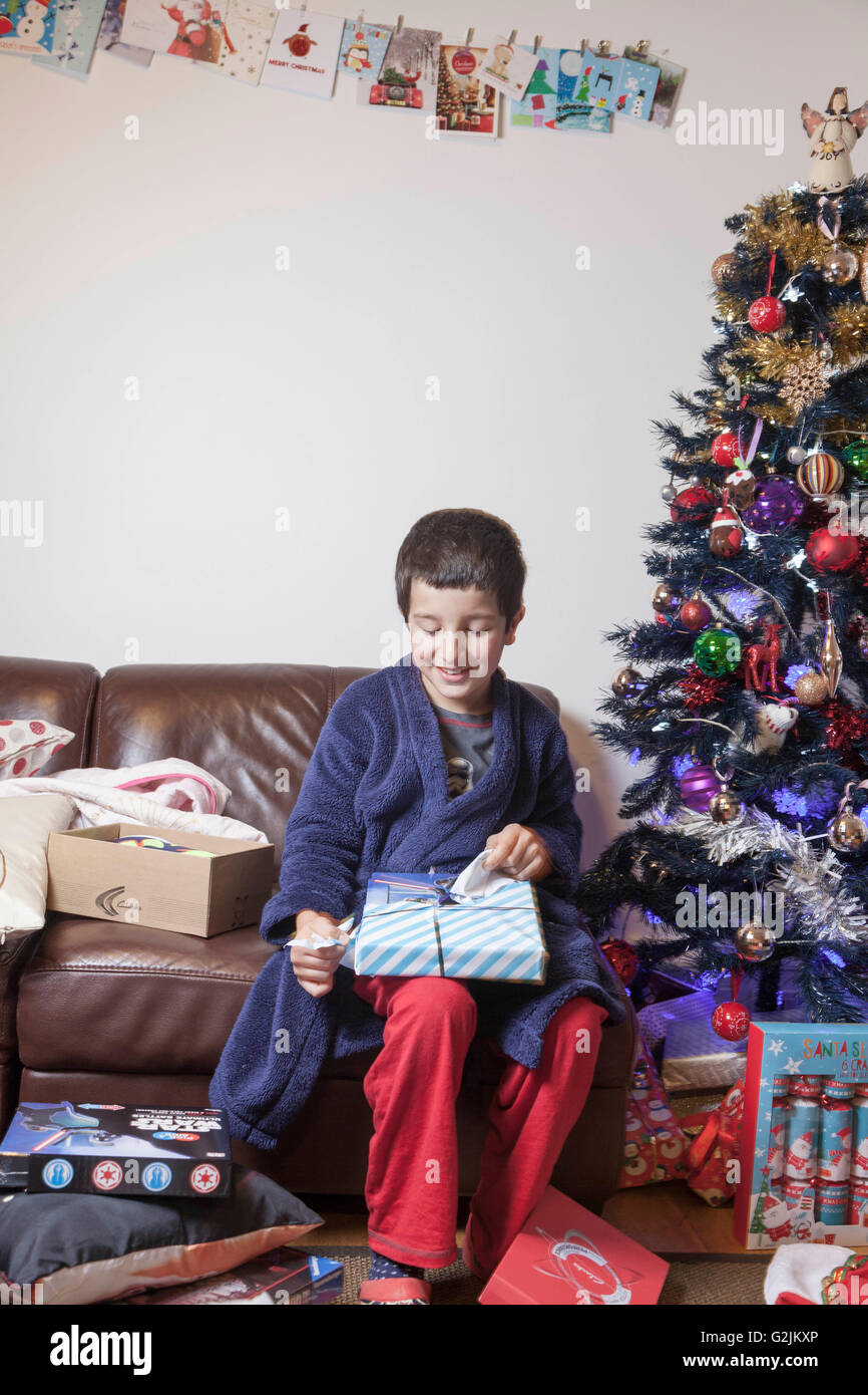 Boy,unwrapping Christmas presents Stock Photo