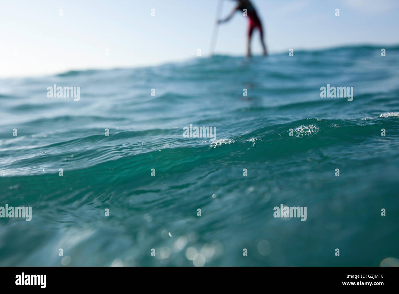 Davide Giardini stand up paddle boarding, surfing off of Diamond Head