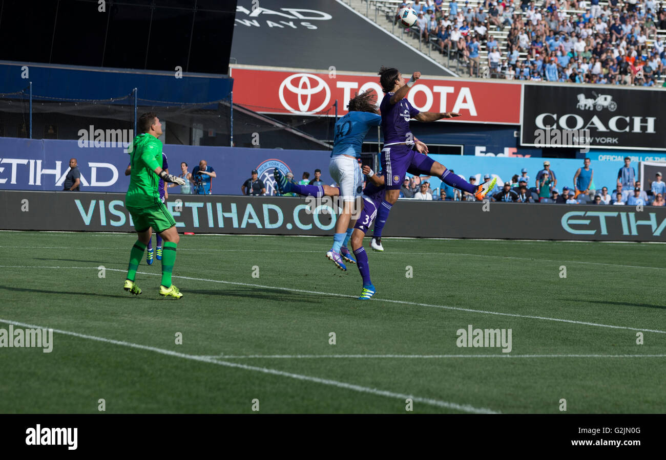 New York, NY USA - May 29, 2016: Mix Diskerud (10) of NYC FC & Seb Hines (3) of Orlando City SC fight for air ball during MLS match on Yankee stadium Stock Photo