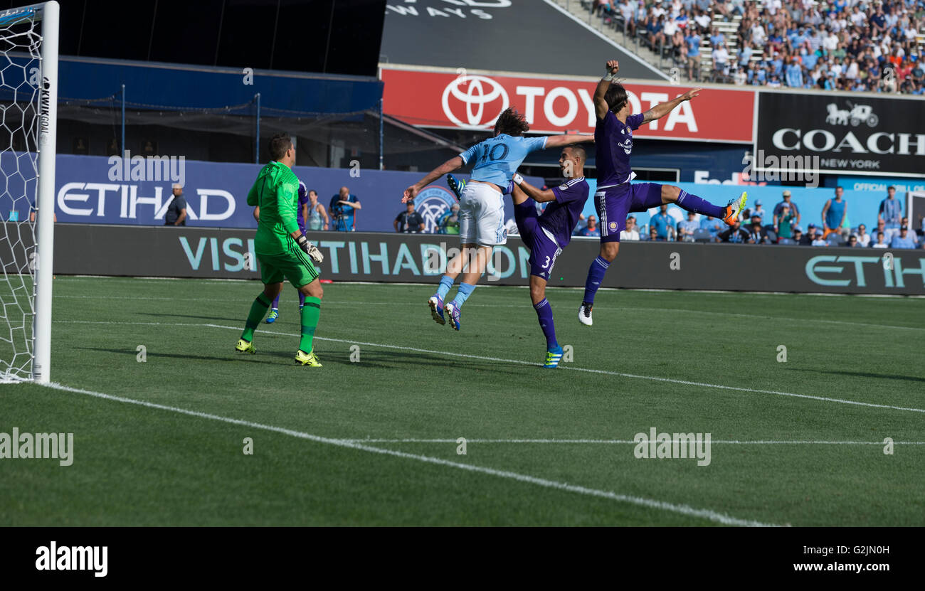 New York, NY USA - May 29, 2016: Mix Diskerud (10) of NYC FC & Seb Hines (3) of Orlando City SC fight for air ball during MLS match on Yankee stadium Stock Photo