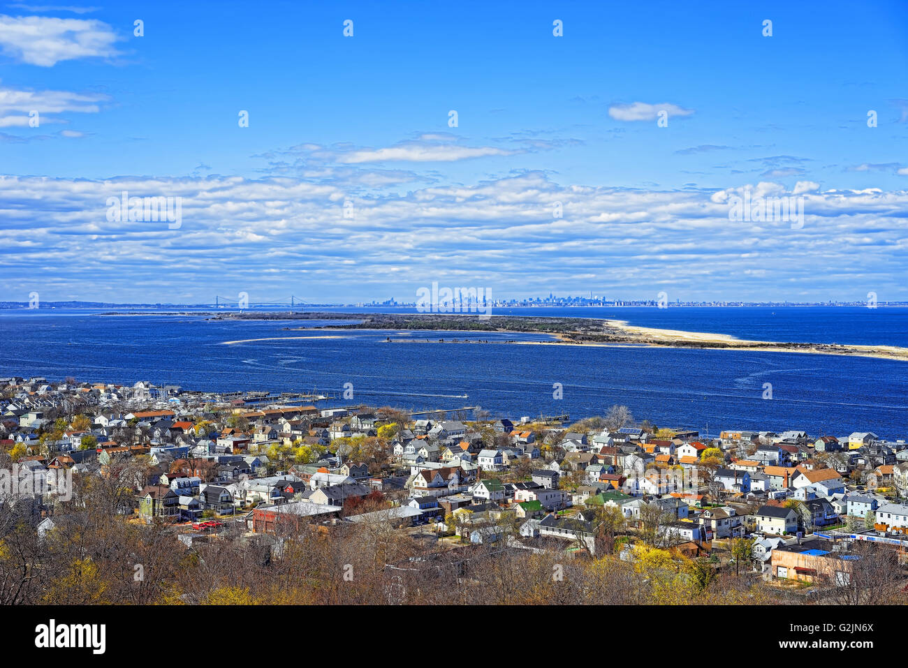 Houses and Atlantic Ocean shore at Sandy Hook with a view of NYC. View