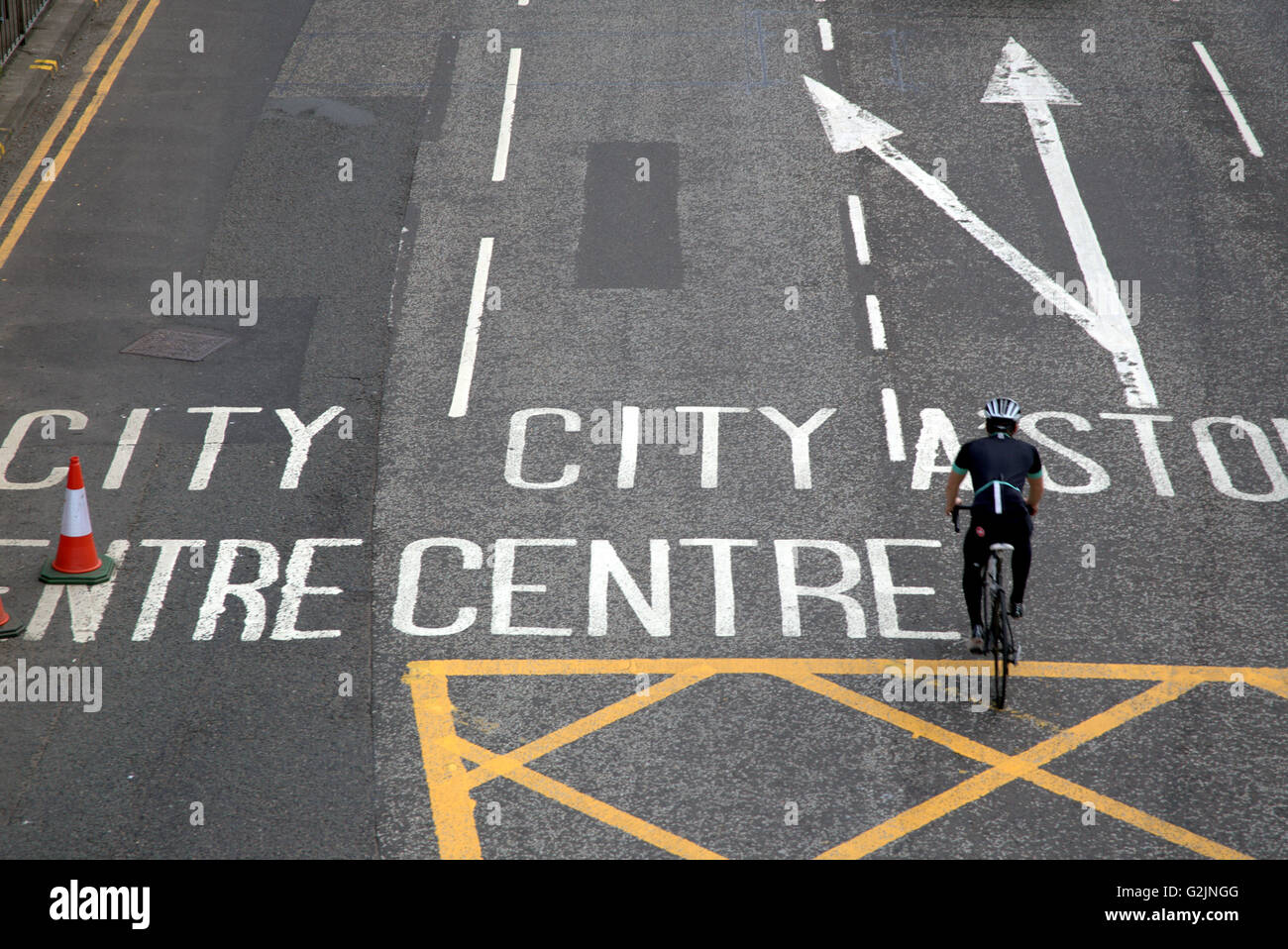man on bicycle riding on road to city centre Glasgow, Scotland, UK. Stock Photo
