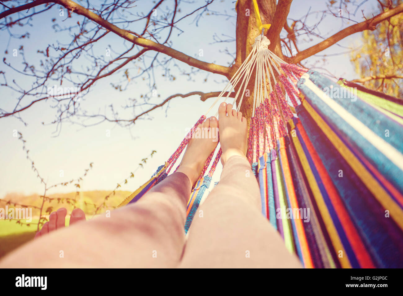 Resting legs in hammock Stock Photo