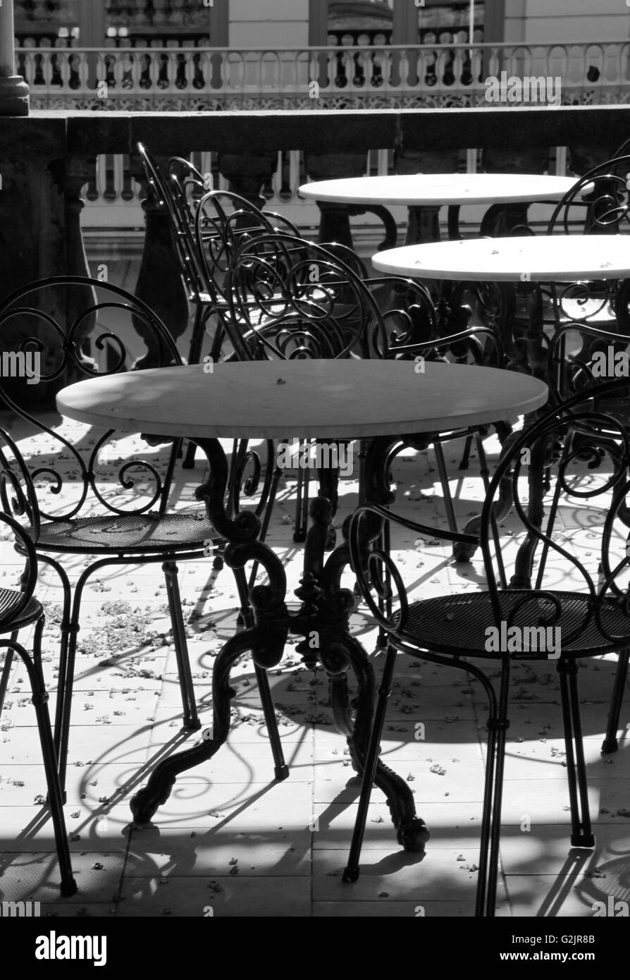 Marble, topped tables, cast iron, chair, balcony black and white, patio, outdoor, cafe, restaurant, alfresco, cafeteria, seating, ornamental, elegant. Stock Photo