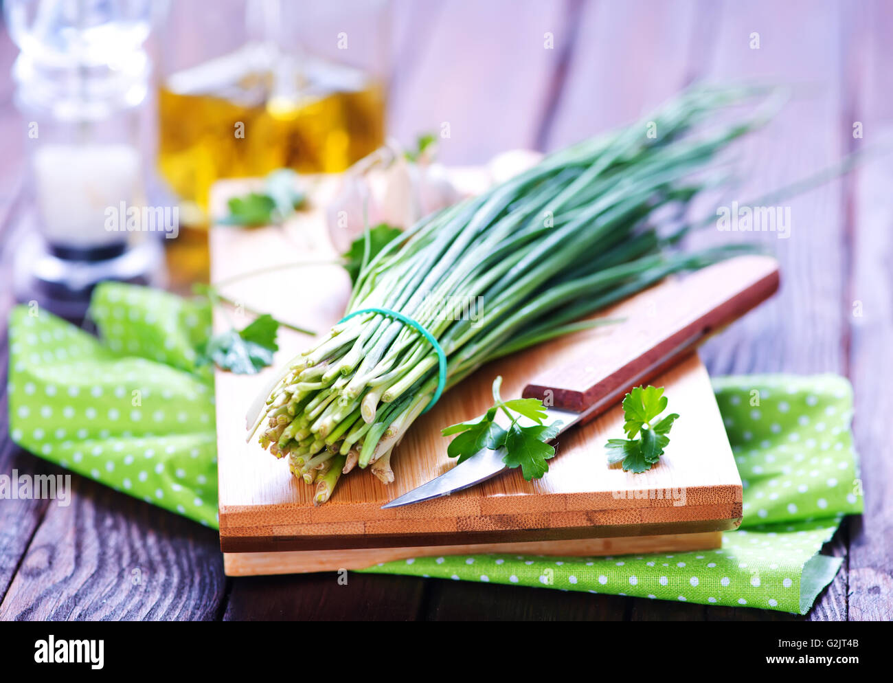 green onion on board and on a table Stock Photo - Alamy