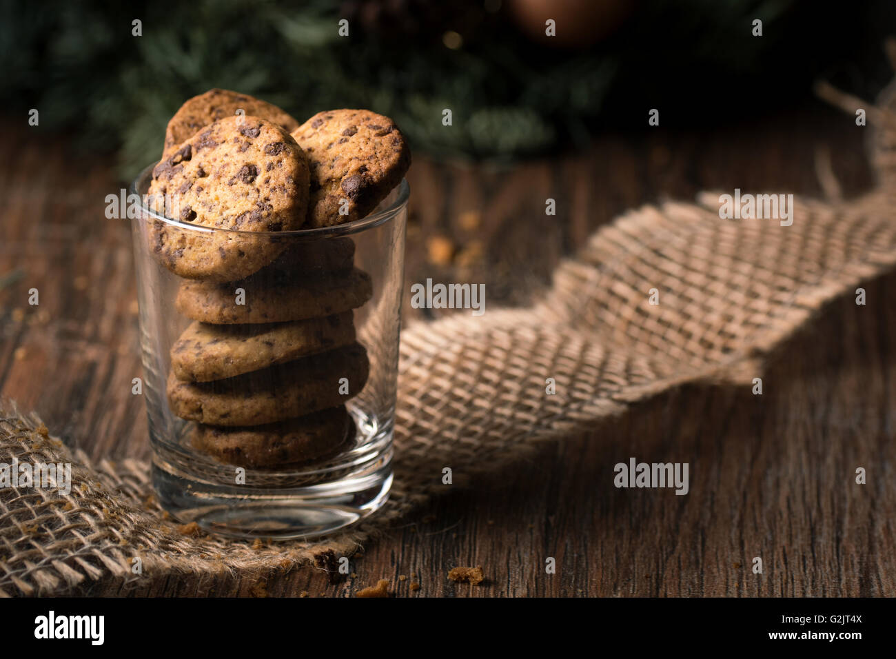 Fresh baked chocolate chip cookies in a glass on a rustic wooden table. Stock Photo