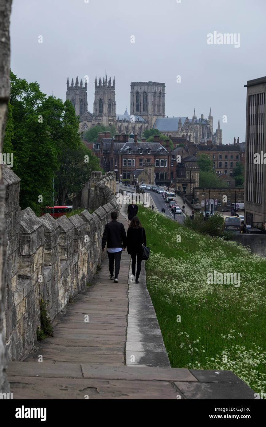 Couple stroll hand in hand along the old city walls of hostoric York, England Stock Photo