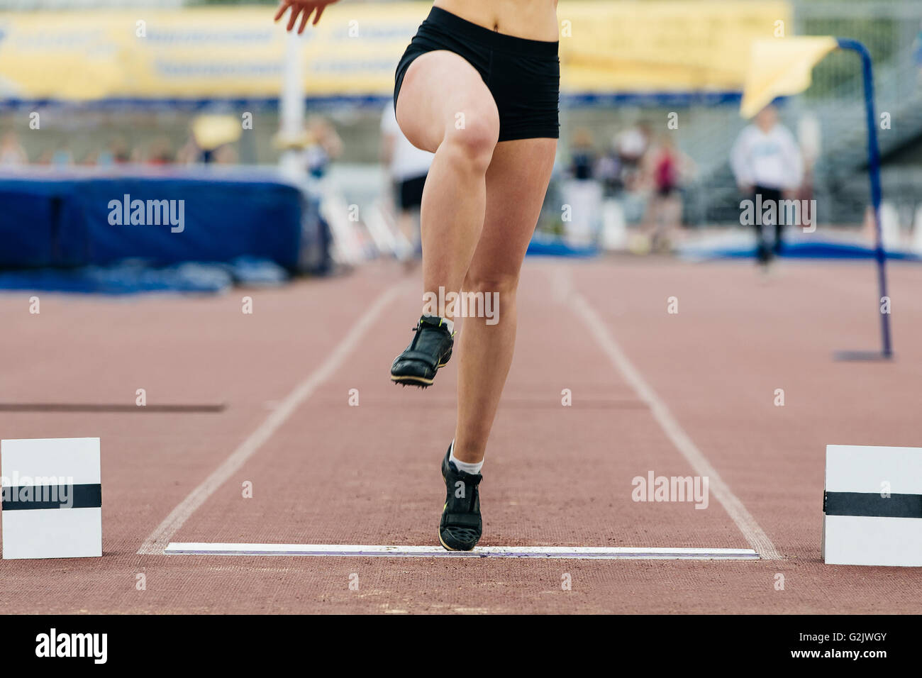 girl athlete of long jump. only foot jump from wooden board Stock Photo