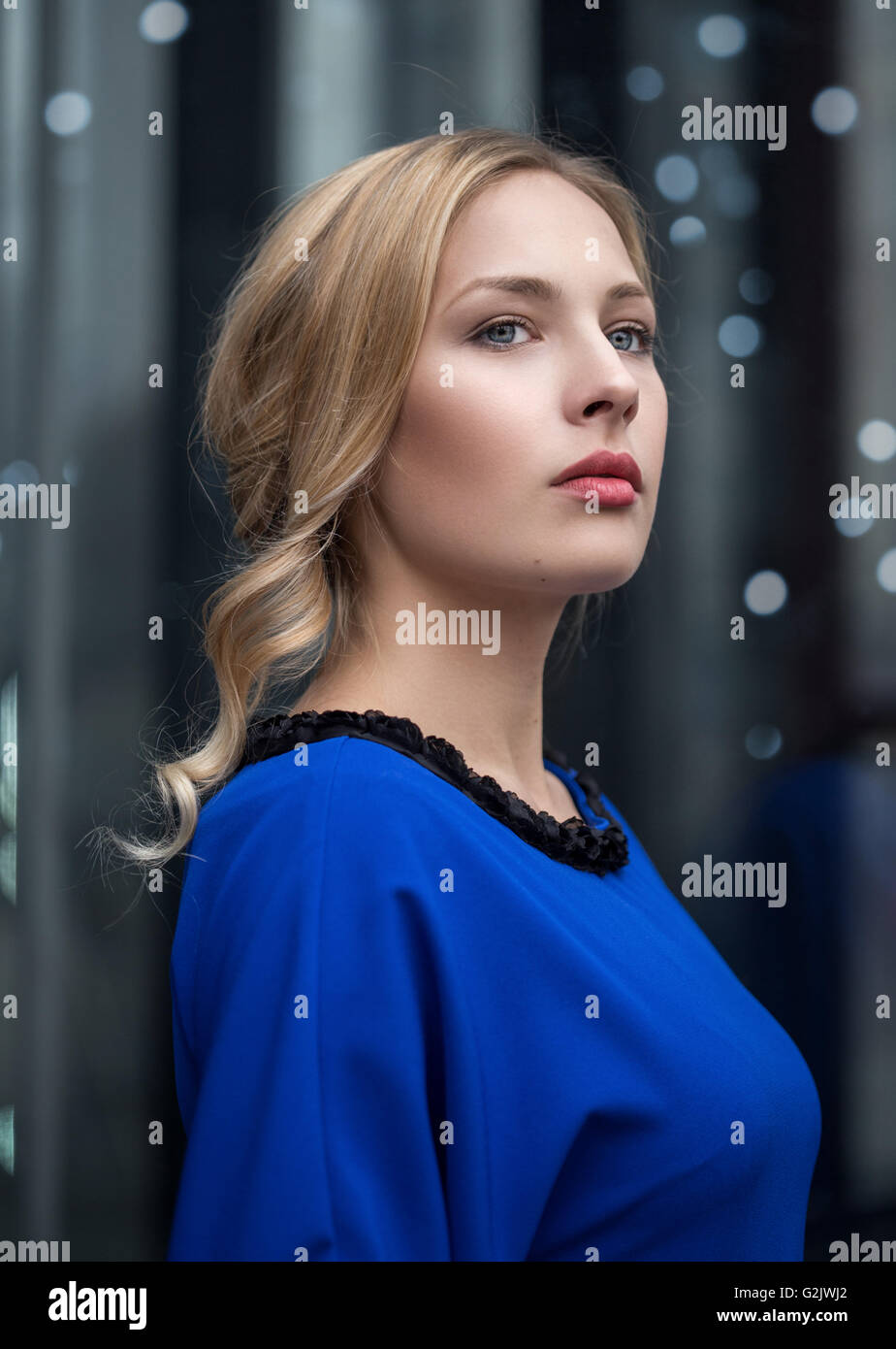 Closeup portrait of a beautiful young woman in blue dress Stock Photo ...