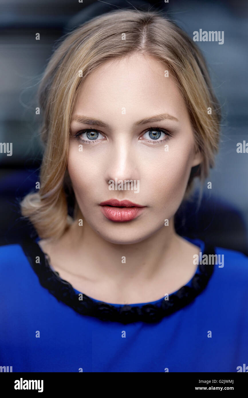 Closeup portrait of a beautiful young woman in blue dress Stock Photo ...