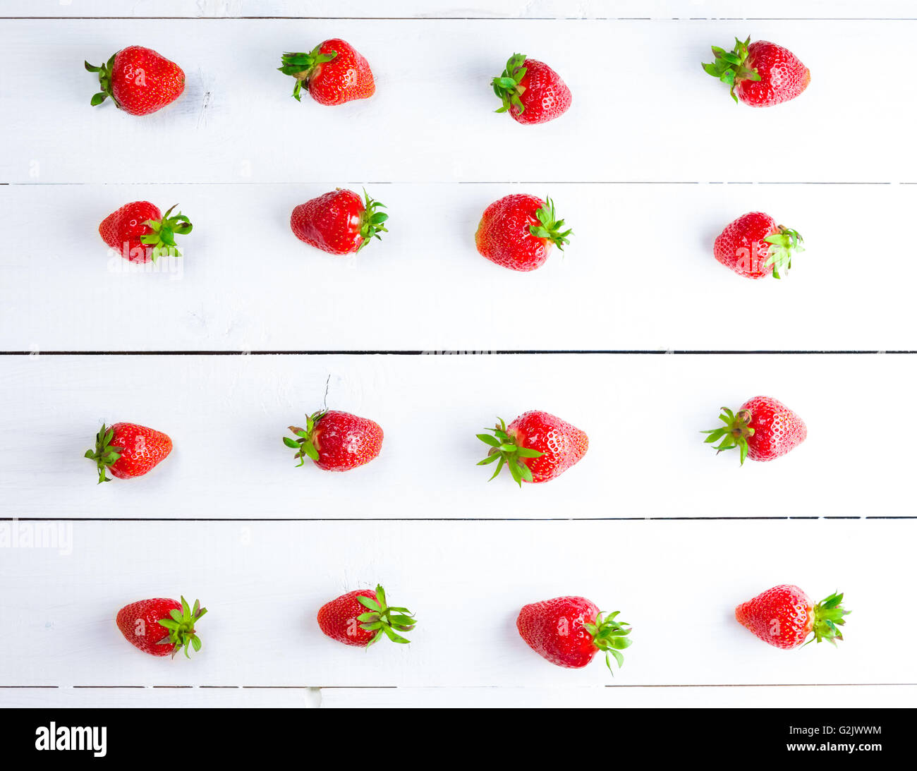 Beautiful background with fresh ripe strawberries on white wooden ...