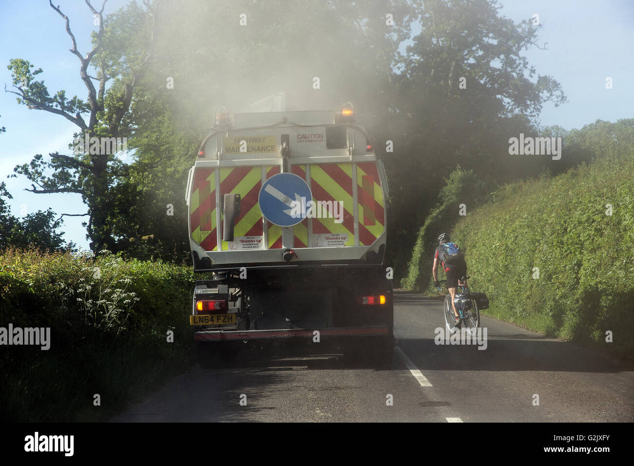 bike overtaking a lorry on country road, biking, two, men, road, endurance, cyclist, motion blur, race, course, sunny, competiti Stock Photo