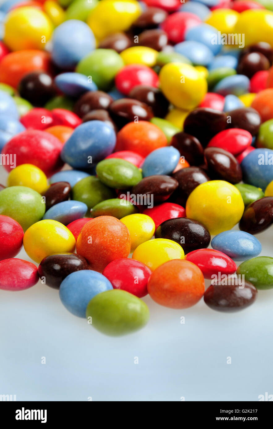 Many candies on blue background Stock Photo - Alamy