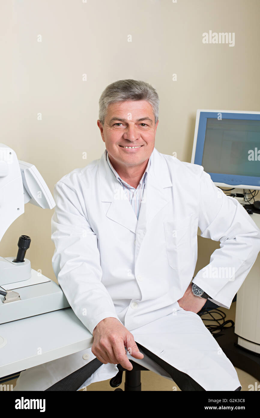 portrait of handsome elderly eye doctor Stock Photo