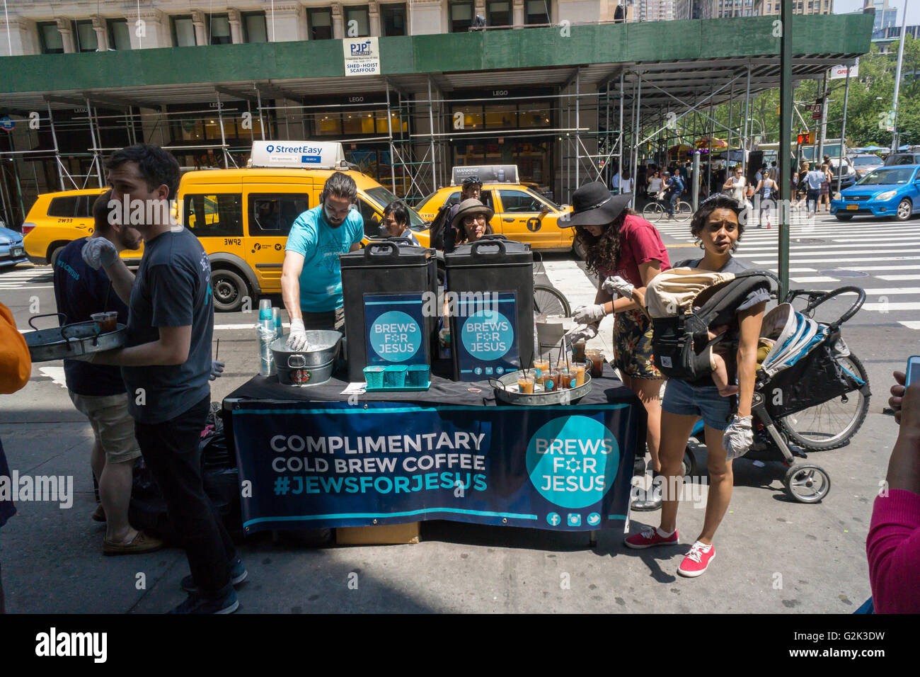 Members of Jews For Jesus give away complimentary cups of iced coffee in New York on Wednesday, May 25, 2016 as part of their seasonal outreach. Jews For Jesus is a Messianic congregation which are Christian congregations that employ Jewish forms of worship, including synagogues, the ritual blowing of the shofar (ram's horn), the use of Hebrew in liturgy and other similarities. However the Christian congregations believe in Jesus as the Messiah which is not found in Judaism.. (© Richard B. Levine) Stock Photo