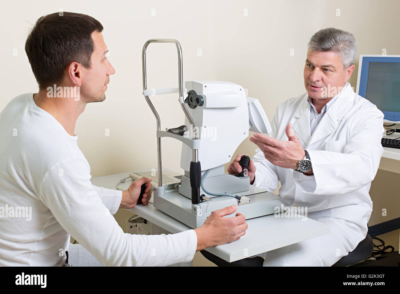 Man having his eyes examined by an eye  elderly doctor. Stock Photo