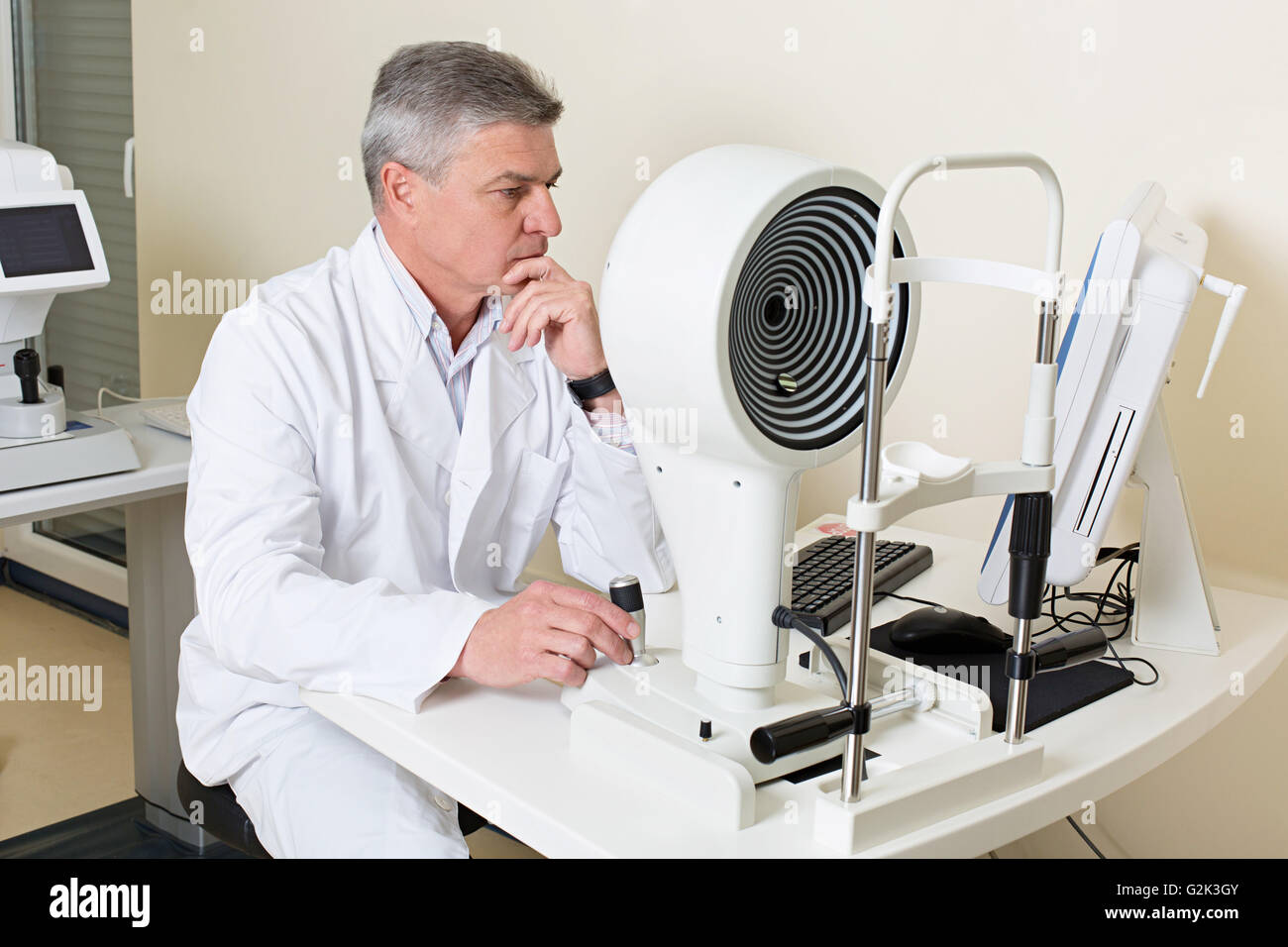 ophthalmologist sitting near the equipment Stock Photo
