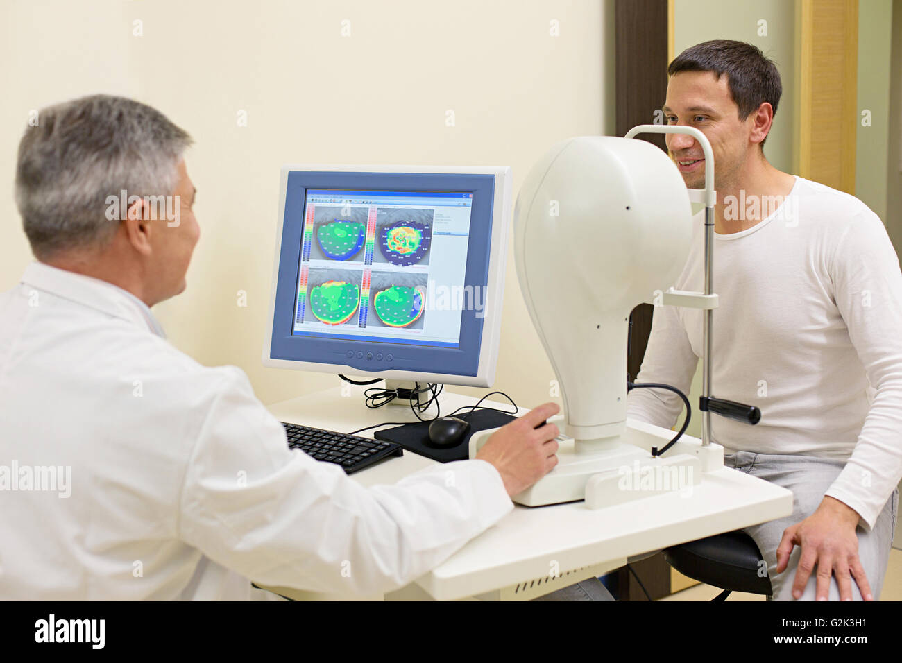 Man having his eyes examined by an eye elderly doctor. Stock Photo