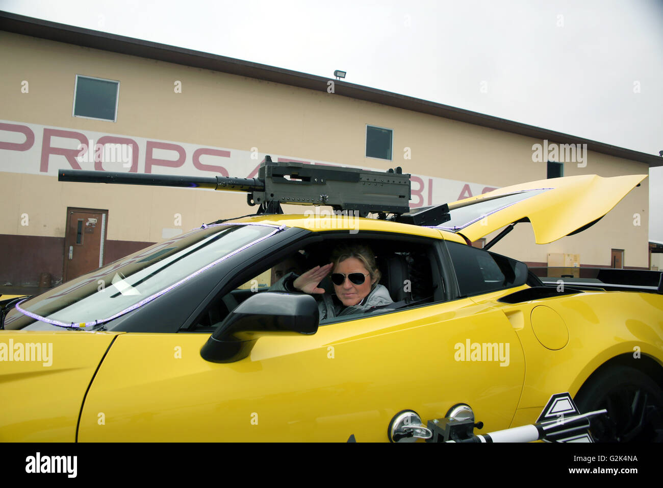Professional race driver and host of the BBC television show Top Gear Sabine Schmitz, salutes the camera from inside a car rigged with prop weapons during a Top Gear special filmed at Naval Air Station Fallon January 10, 2016 in Fallon, Nevada. Naval Air Station Fallon is where the Navy Top Gun fighter pilots train. Stock Photo